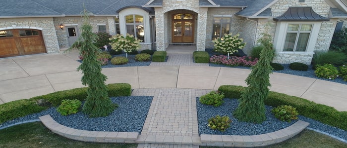 landscaping in the front of a large circle drive