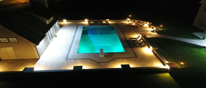 outdoor lighting lit pool with beautiful poolscaping