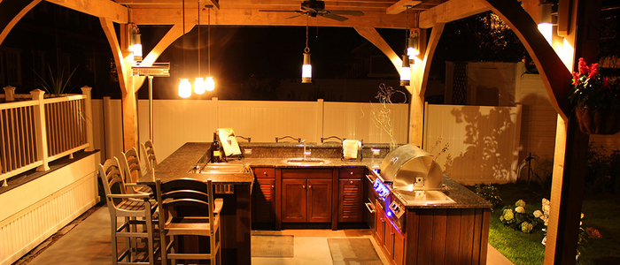 Image of an outdoor kitchen and bar area with cabinets from Naturkast.