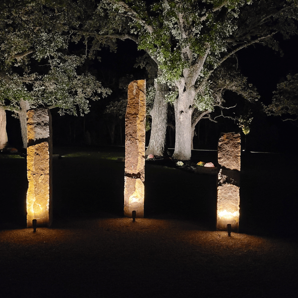 These stones are lit with outdoor LEDs, that direct light toward them. 