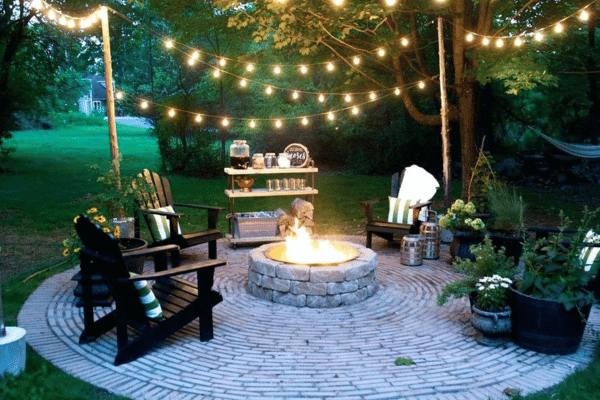 Outdoor sitting area with landscape lighting enhancement.